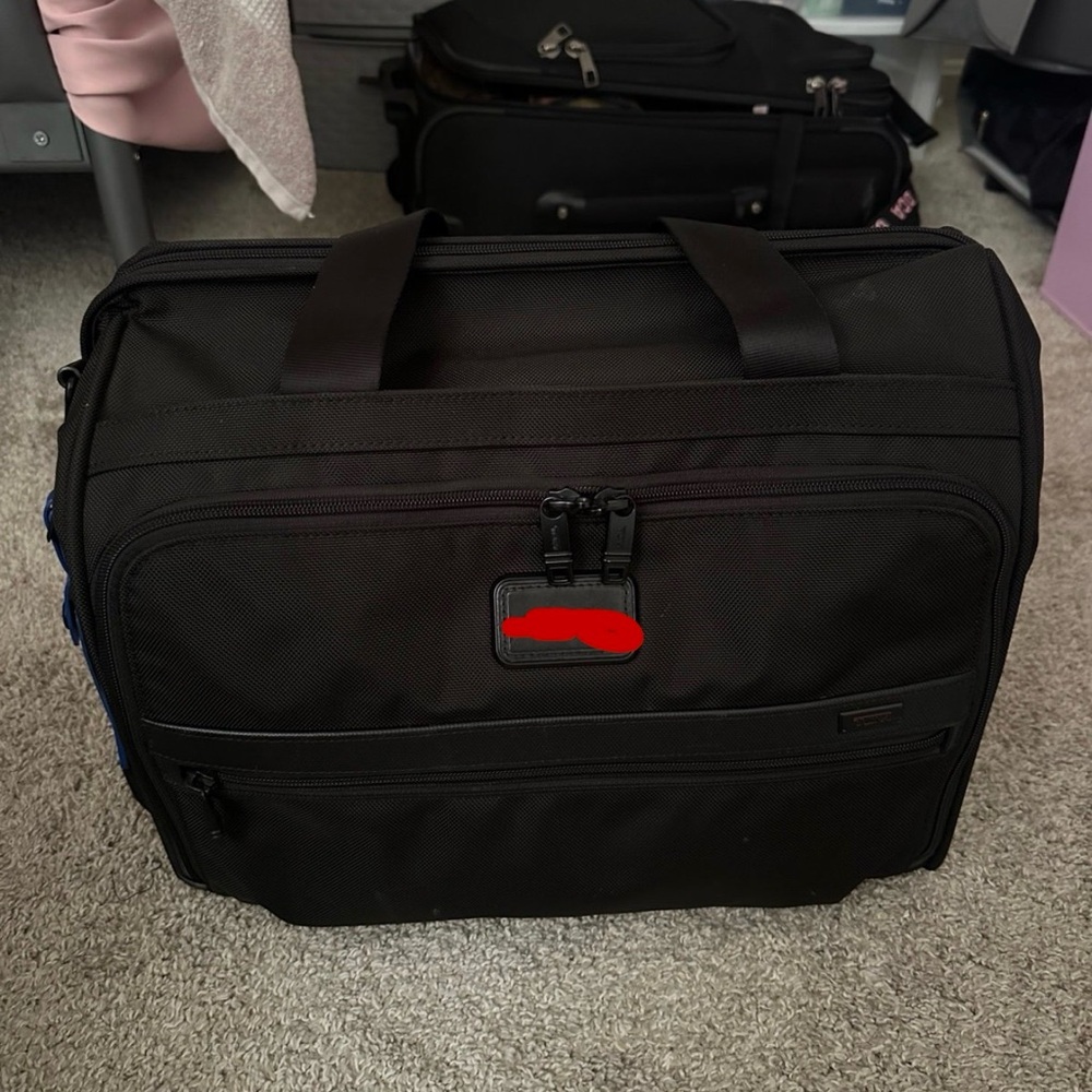Tumi carry-on bag.